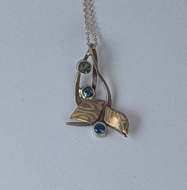 3 shades of sapphires set in 18k white gold and mokume gane pendant