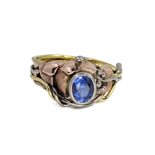 Asymmetrical ring with bezel set purple sapphire