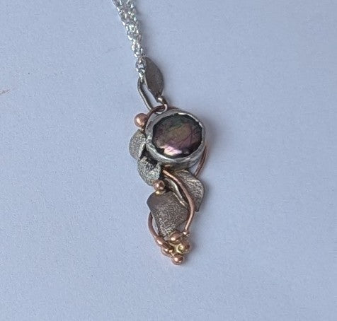 Black Pearl set in rose and white gold pendant