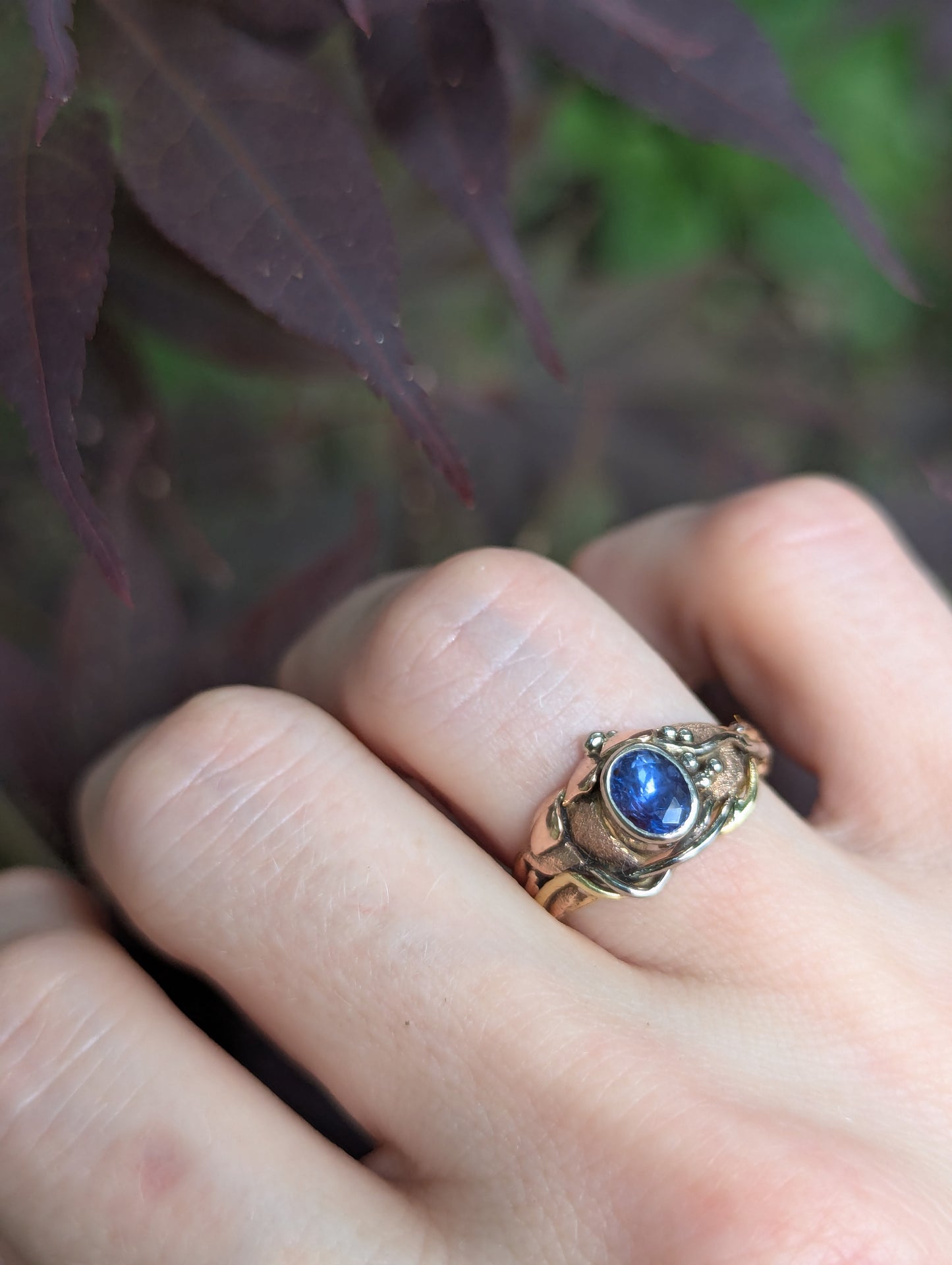 Asymmetrical ring with bezel set purple sapphire