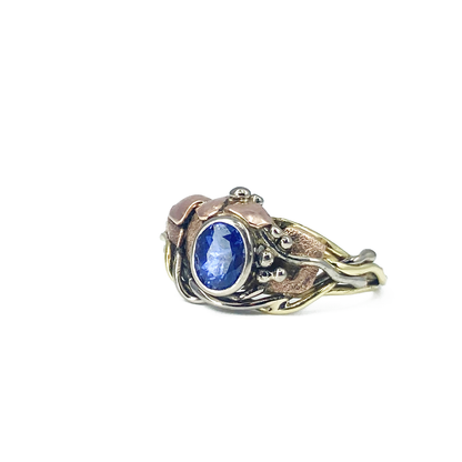 Asymmetrical ring with bezel set purple sapphire