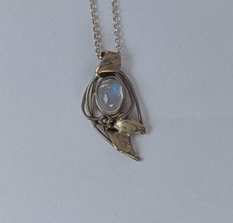 Rainbow moonstone set in 18k white gold with Mokume gane