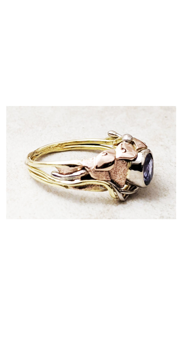 Asymmetrical design ring with bezel set purple sapphire