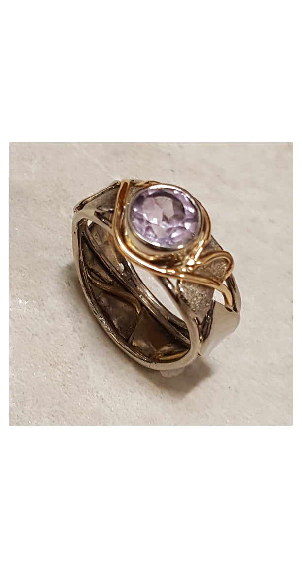 Band style ring with bezel set amethyst